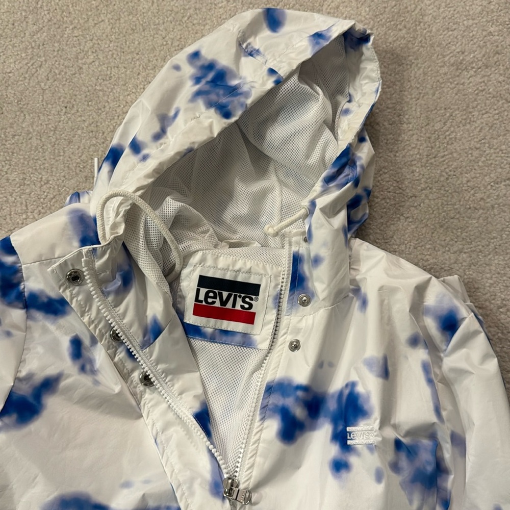 Lightweight hooded white and blue jacket.